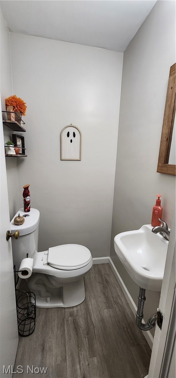1293 Brainard Road Lyndhurst, OH 44124 - Photo 9 of 15 Half Bathroom with toilet, sink, and vinyl flooring