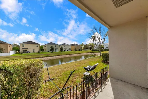 a view of a lake with couches in front of house