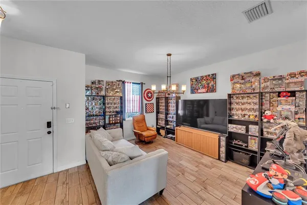 a living room with furniture and a wooden floor