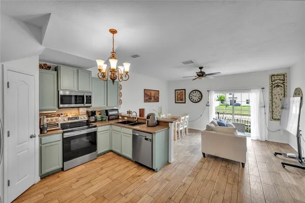 a kitchen with stainless steel appliances granite countertop a stove and cabinets