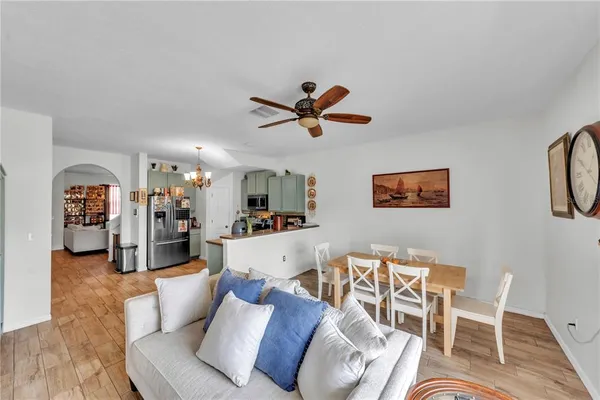 a living room with furniture and a ceiling fan