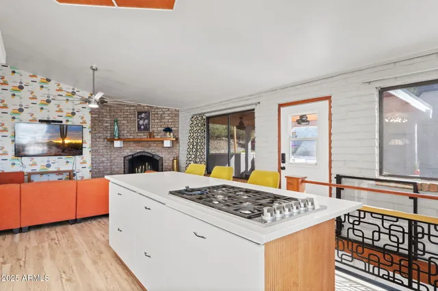 a kitchen with a sink a large window and a chandelier