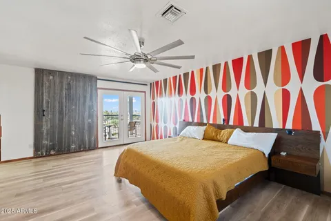 a bedroom with a bed and a flat screen tv