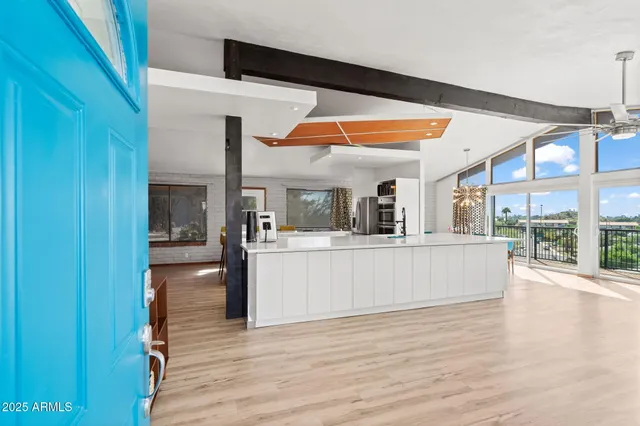 a view of living room with kitchen island furniture and wooden floor