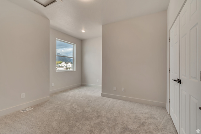 2535 West Santa Fe Drive Mapleton, UT 84664 - Photo 19 of 26 Unfurnished bedroom with a closet, light colored carpet, and recessed lighting