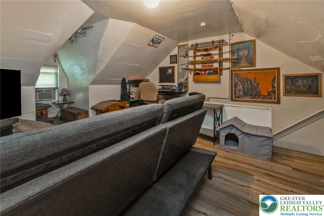 365 Rock Street Easton, PA 18042 - Photo 33 of 50 Slanted ceilings and light wood-like flooring define this adaptable loft area, perfect for a home office or creative retreat.