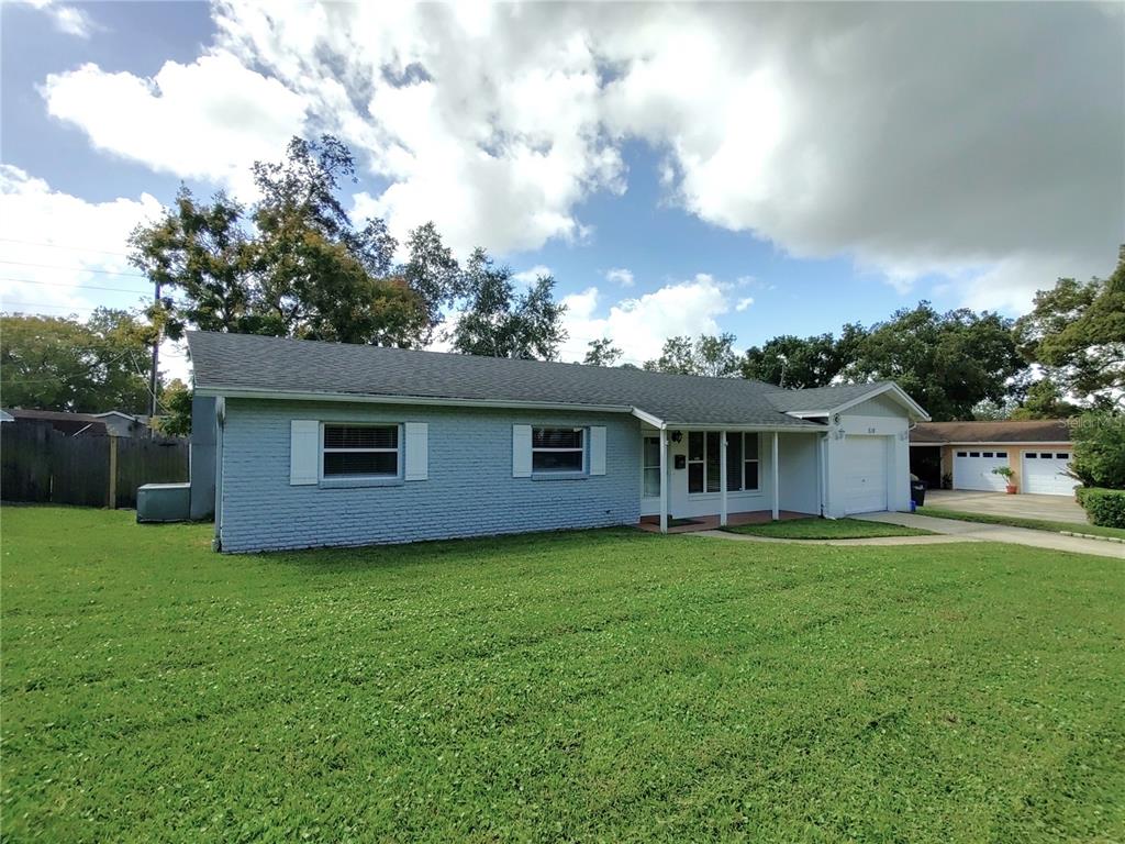 516 Ellsworth Street Altamonte Springs, FL 32701 - Photo 1 of 30 a house that is sitting in the grass with large trees