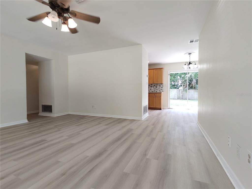 516 Ellsworth Street Altamonte Springs, FL 32701 - Photo 11 of 30 wooden floor in an empty room with a window