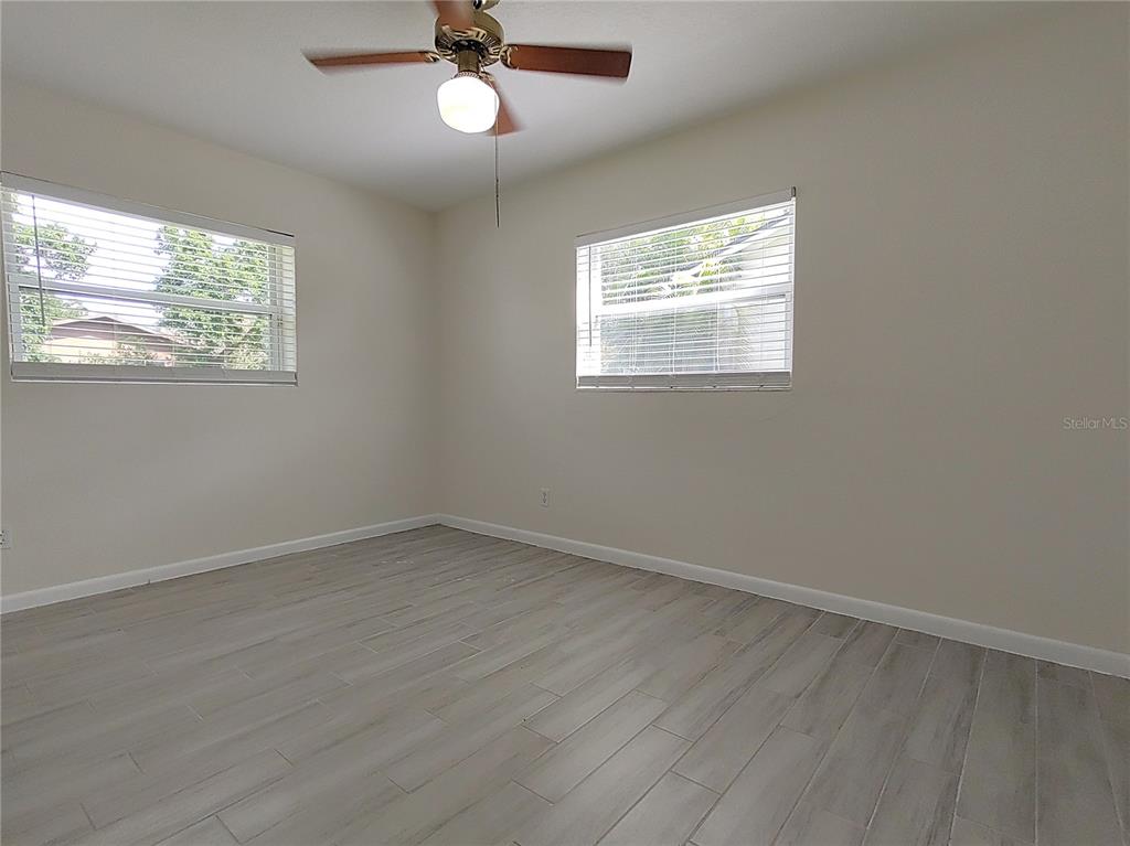 516 Ellsworth Street Altamonte Springs, FL 32701 - Photo 13 of 30 an empty room with wooden floor and windows