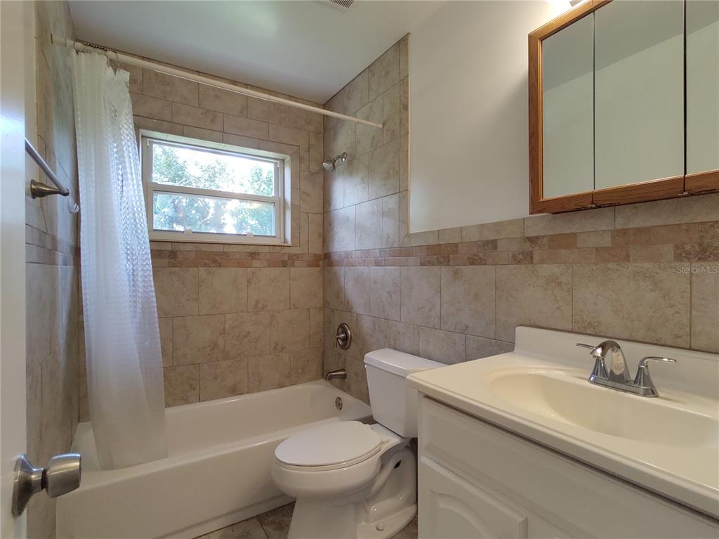 516 Ellsworth Street Altamonte Springs, FL 32701 - Photo 14 of 30 a bathroom with a sink toilet and shower