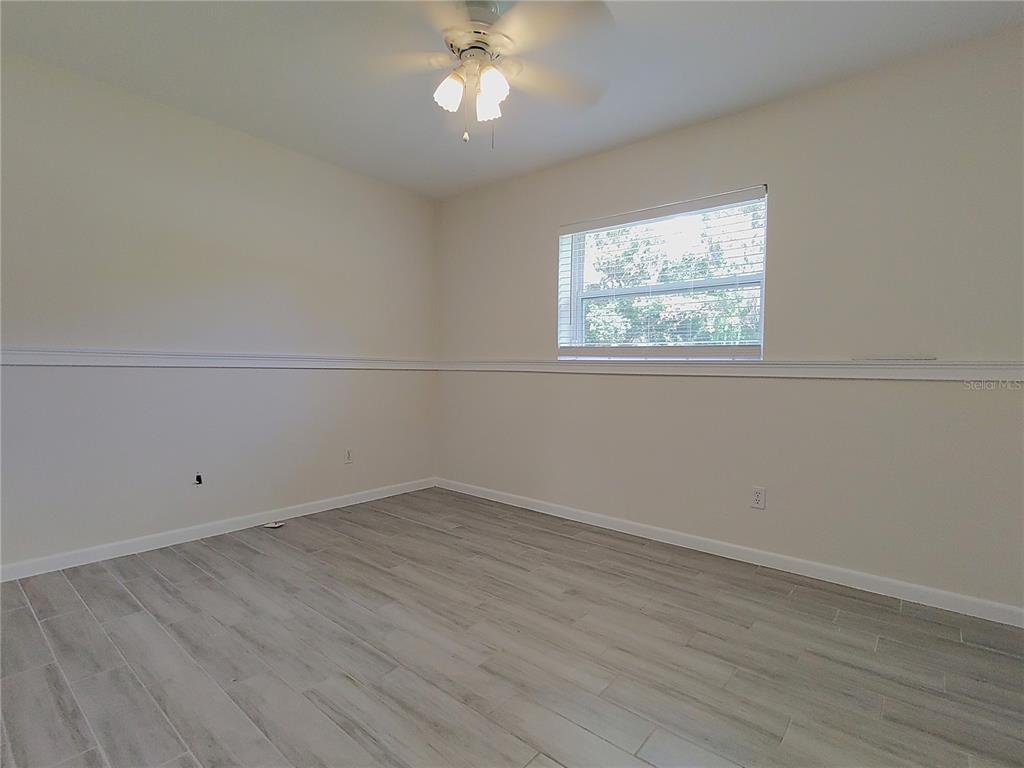 516 Ellsworth Street Altamonte Springs, FL 32701 - Photo 15 of 30 an empty room with wooden floor and windows