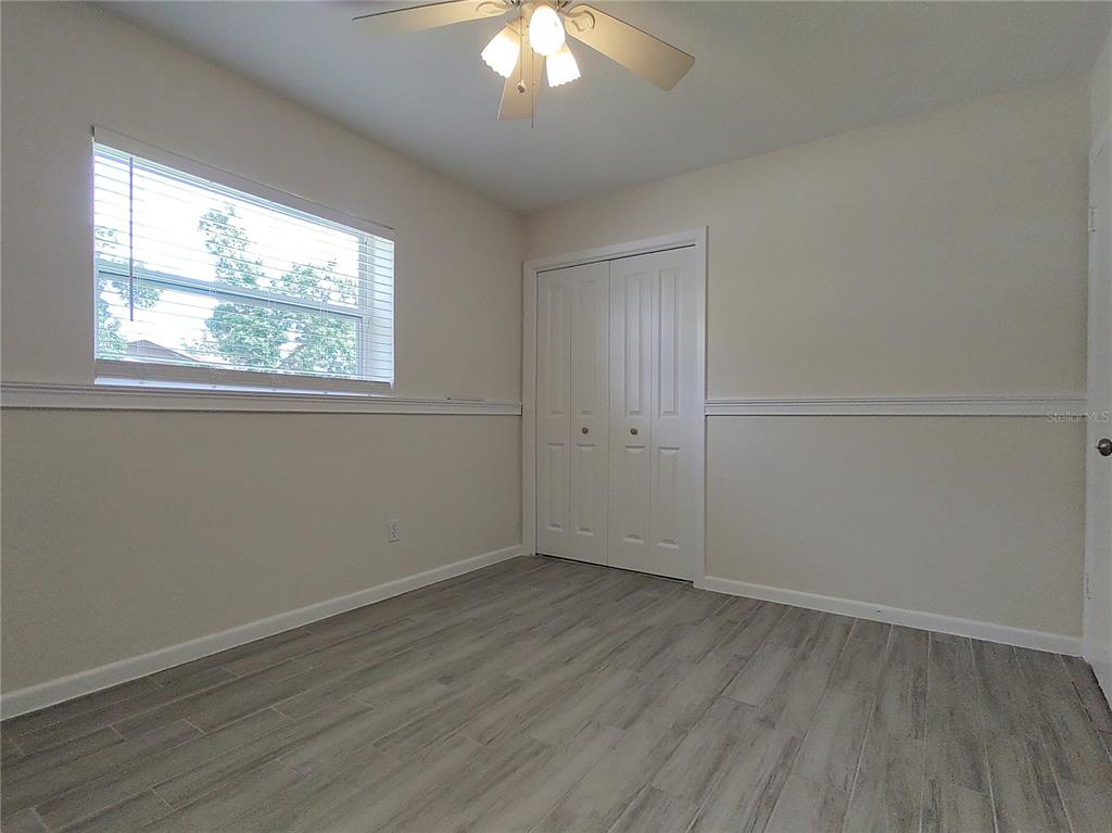 516 Ellsworth Street Altamonte Springs, FL 32701 - Photo 16 of 30 an empty room with wooden floor and windows