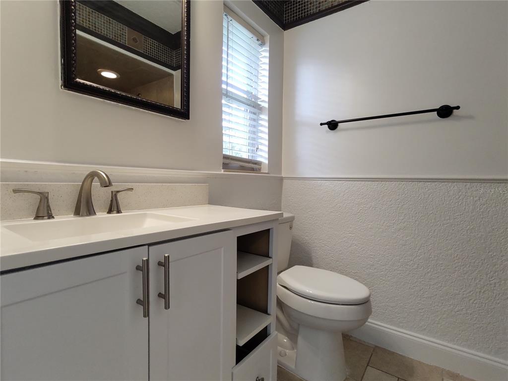 516 Ellsworth Street Altamonte Springs, FL 32701 - Photo 17 of 30 a bathroom with a toilet a sink and mirror