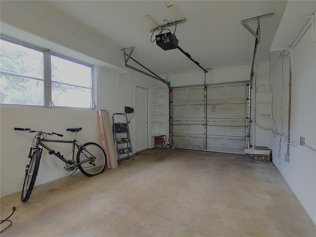 516 Ellsworth Street Altamonte Springs, FL 32701 - Photo 22 of 30 a view of a garage with rack and bicycle