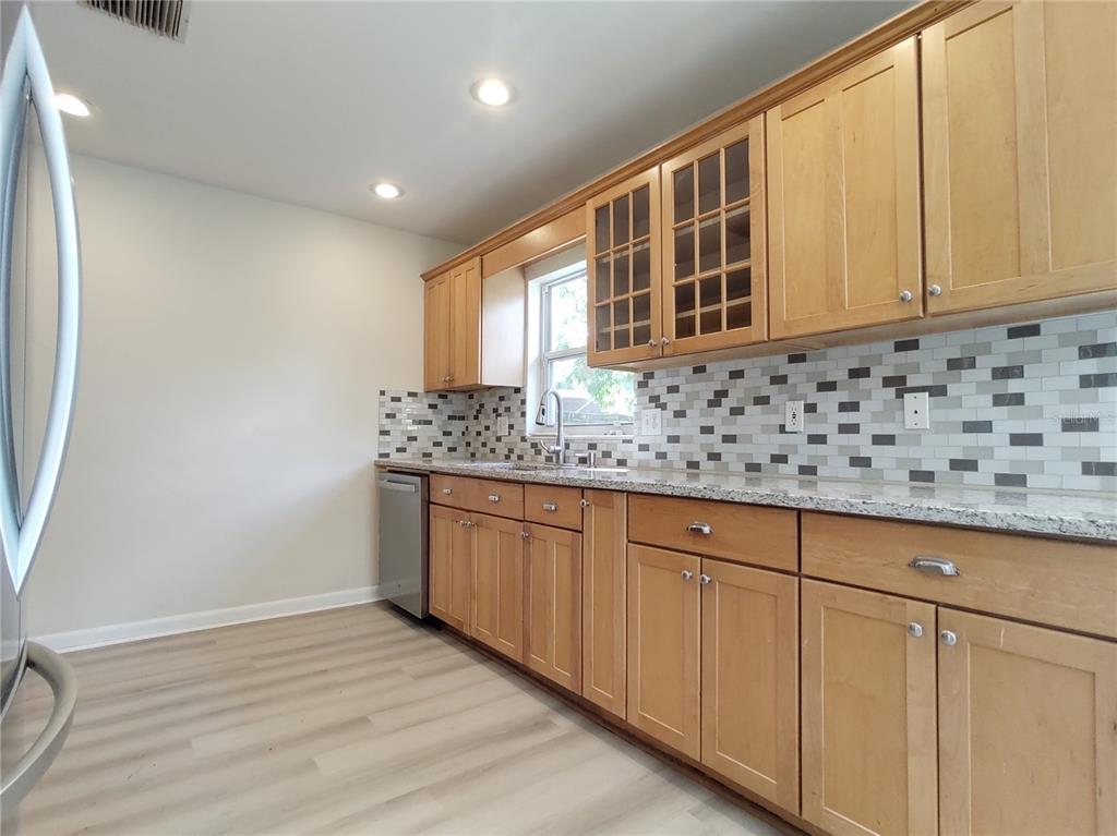 516 Ellsworth Street Altamonte Springs, FL 32701 - Photo 6 of 30 a kitchen with granite countertop a sink and cabinets