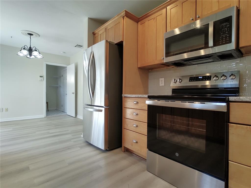 516 Ellsworth Street Altamonte Springs, FL 32701 - Photo 7 of 30 a kitchen with stainless steel appliances a stove a microwave and cabinets