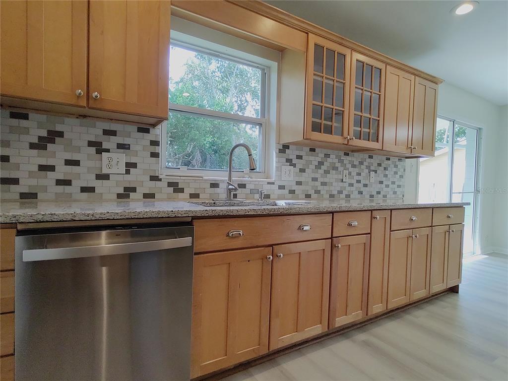 516 Ellsworth Street Altamonte Springs, FL 32701 - Photo 9 of 30 a kitchen with stainless steel appliances granite countertop a sink a stove and a microwave