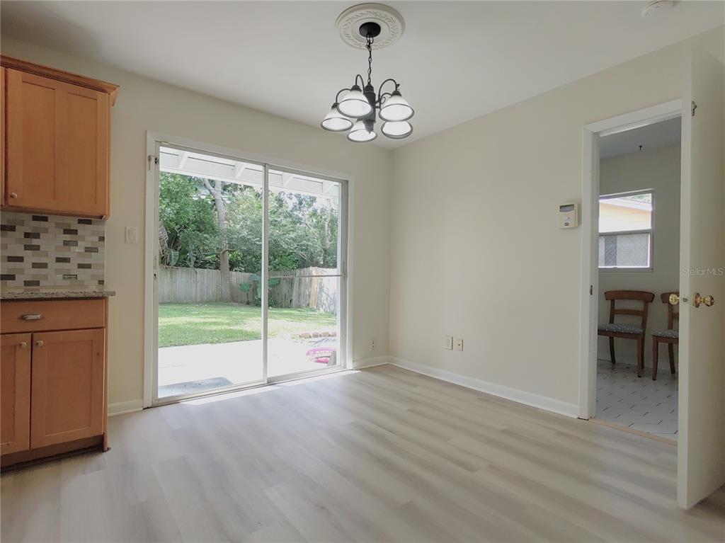 516 Ellsworth Street Altamonte Springs, FL 32701 - Photo 10 of 30 a view of an empty room with wooden floor and a window