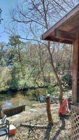 a backyard of a house with lots of green space and fountain