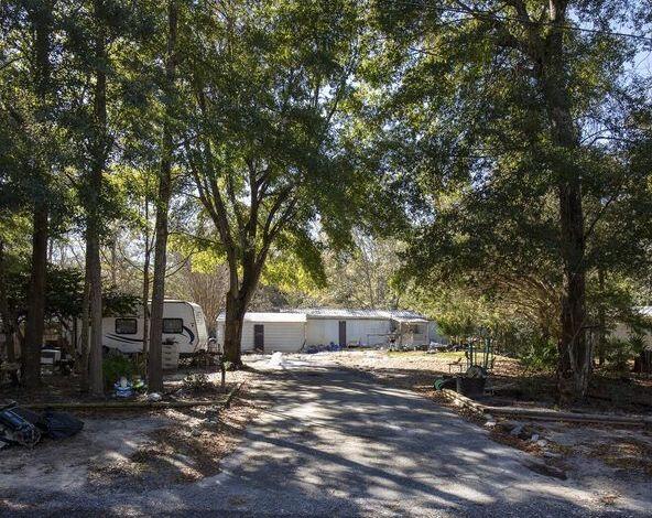 186 Stillwater Road Freeport, FL 32439 - Photo 6 of 8 a view of a outdoor space with a tree