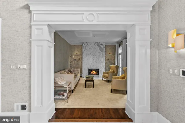 a dining room with furniture a potted plant and wooden floor