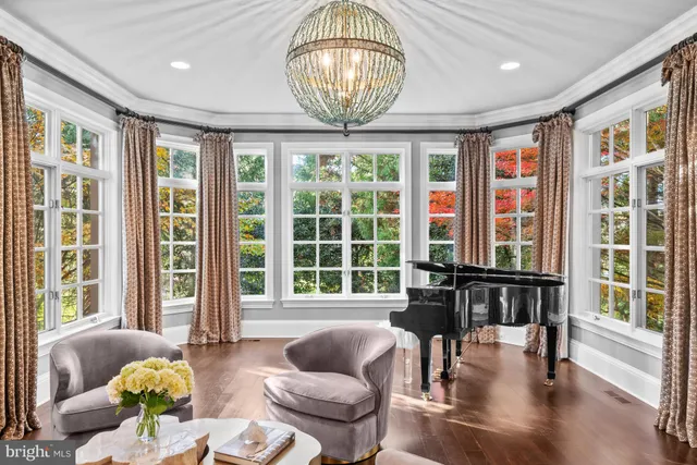a living room with furniture and floor to ceiling windows