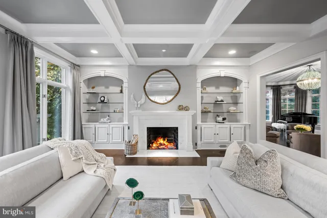 a living room with fireplace furniture and a large window