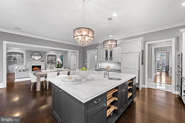 a kitchen with stainless steel appliances a dining table and chairs
