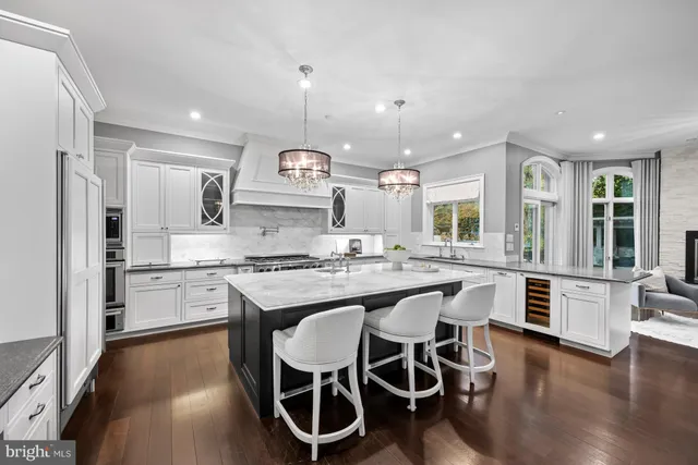 a large kitchen with a table and chairs