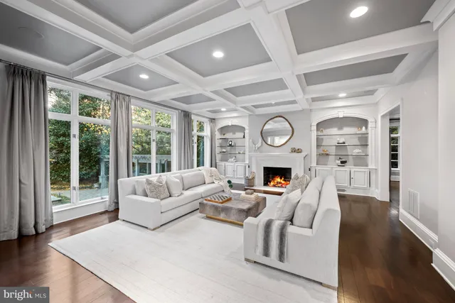 a living room with furniture and large windows