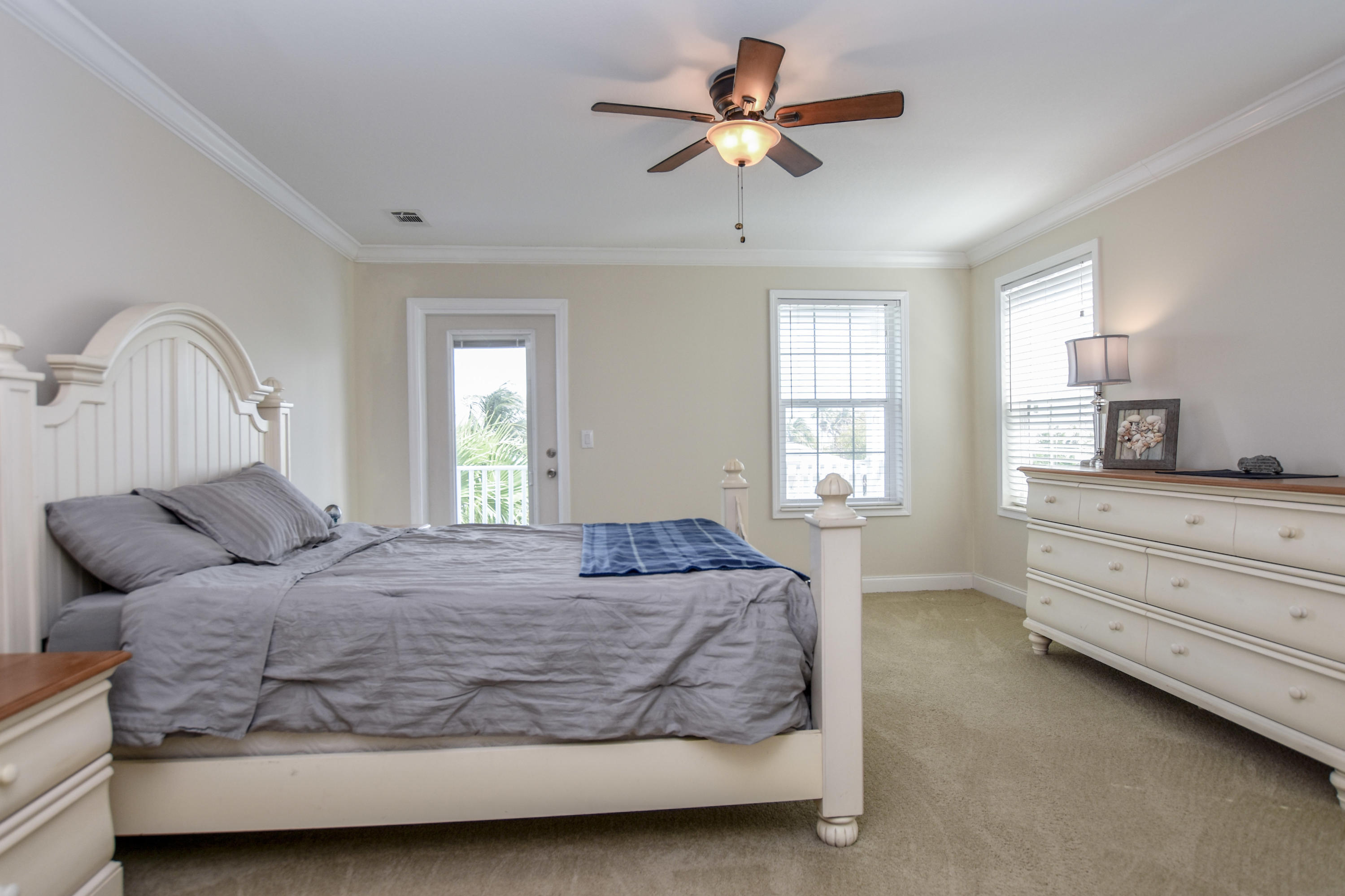 37 Palm Drive Key West, FL 33040 - Photo 11 of 24 a bedroom with a bed a chandelier and dresser