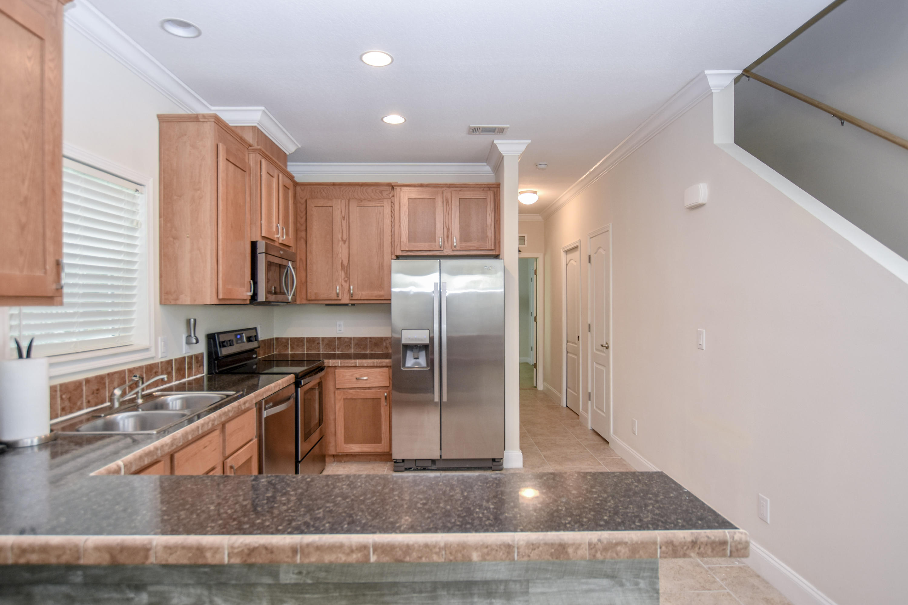 37 Palm Drive Key West, FL 33040 - Photo 4 of 24 a kitchen with stainless steel appliances granite countertop a sink stove and refrigerator