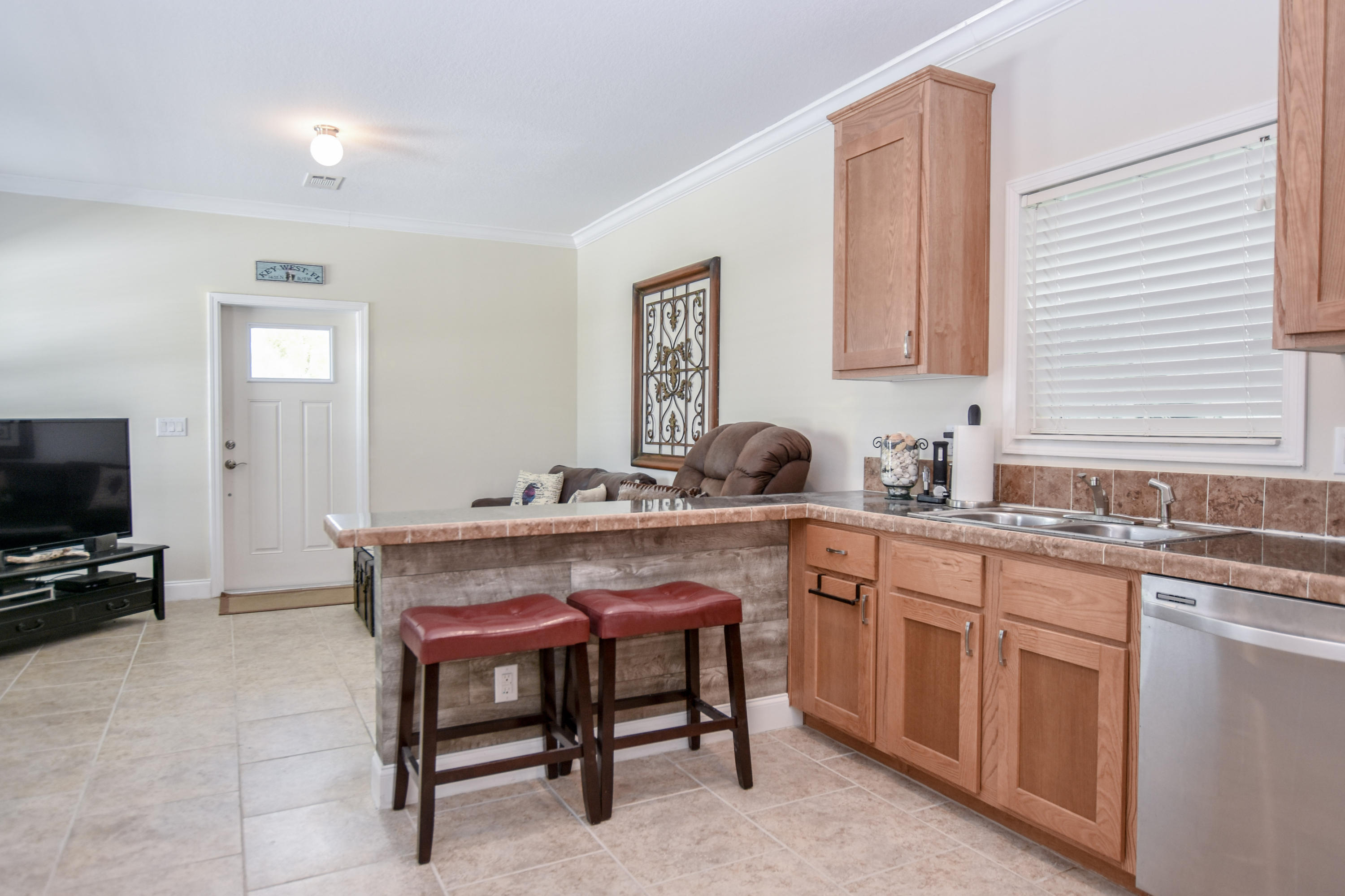 37 Palm Drive Key West, FL 33040 - Photo 7 of 24 a kitchen with sink a table and chairs