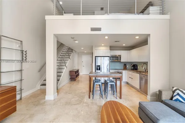 a kitchen with stainless steel appliances kitchen island granite countertop a sink and cabinets