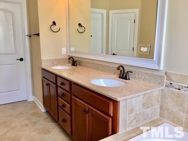8505 Stonechase Drive Raleigh, NC 27613 - Photo 16 of 24 a bathroom with a sink and a mirror