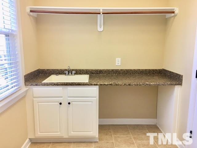 8505 Stonechase Drive Raleigh, NC 27613 - Photo 18 of 24 a bathroom with a granite countertop sink and a mirror