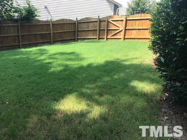 8505 Stonechase Drive Raleigh, NC 27613 - Photo 23 of 24 a view of backyard with wooden fence and a bench