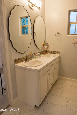 a bathroom with a sink mirror and vanity