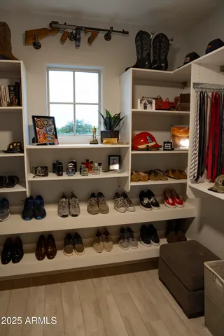 a room with lots of different colored cloths and painting on the wall