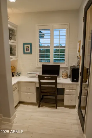 a bedroom with a bed a mirror and a window