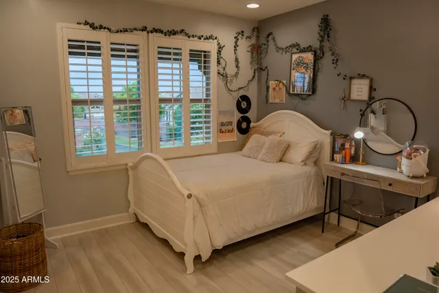 a bedroom with a bed and a large mirror