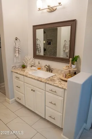 a bedroom with furniture and a mirror