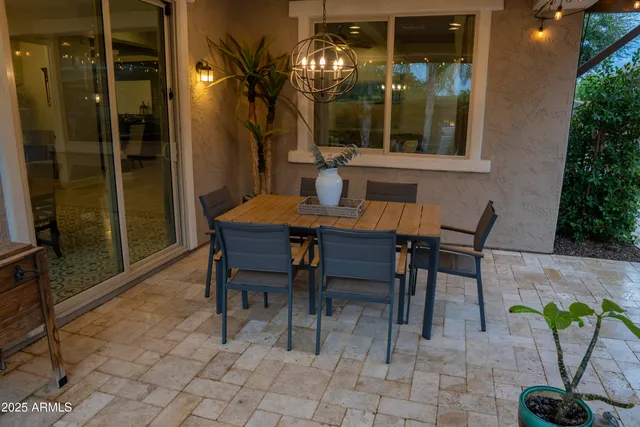 a view of a dining room with furniture and chandelier
