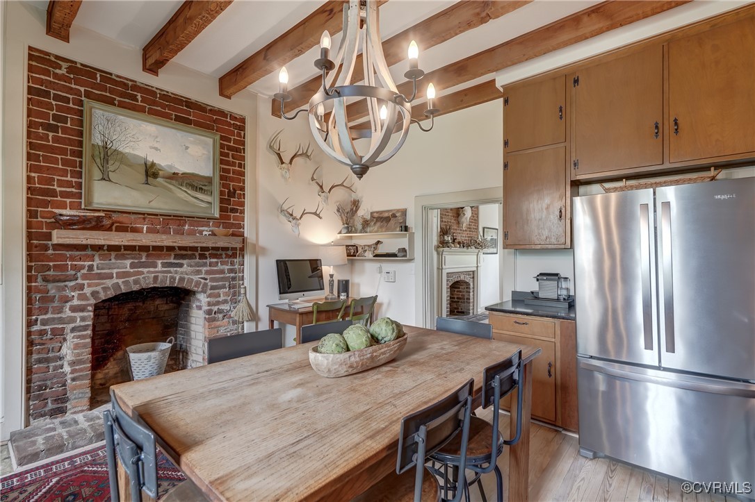 23390 Mt Cloud Road Bowling Green, VA 22427 - Photo 18 of 50 a kitchen with a table chairs refrigerator and cabinets