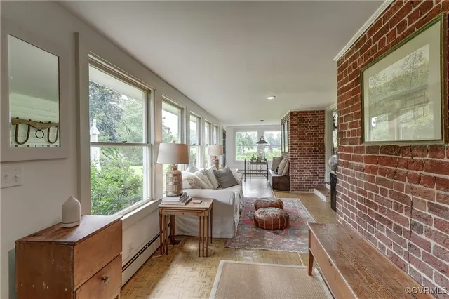 a living room with furniture and a floor to ceiling window