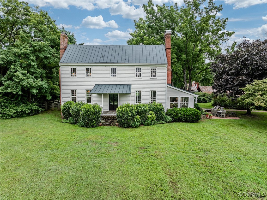 23390 Mt Cloud Road Bowling Green, VA 22427 - Photo 2 of 50 a view of a white house with a yard plants and large tree