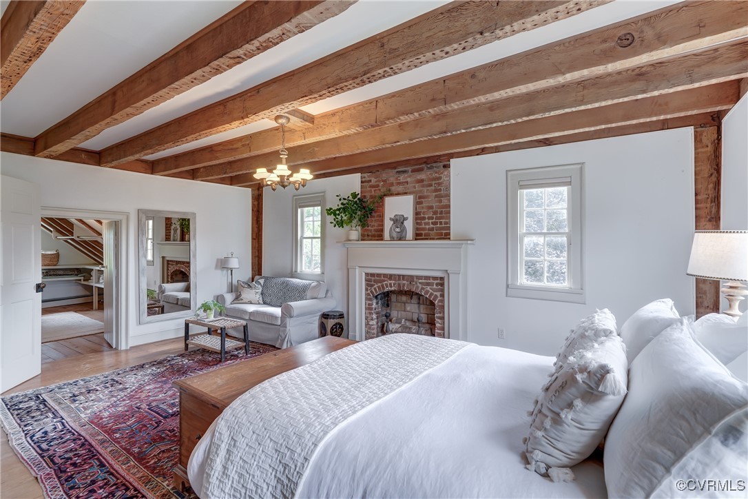 23390 Mt Cloud Road Bowling Green, VA 22427 - Photo 23 of 50 a spacious bedroom with a large bed a fireplace and windows