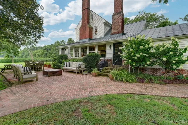 a front view of a house with garden and plants