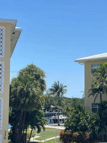 a view of a house with a palm tree