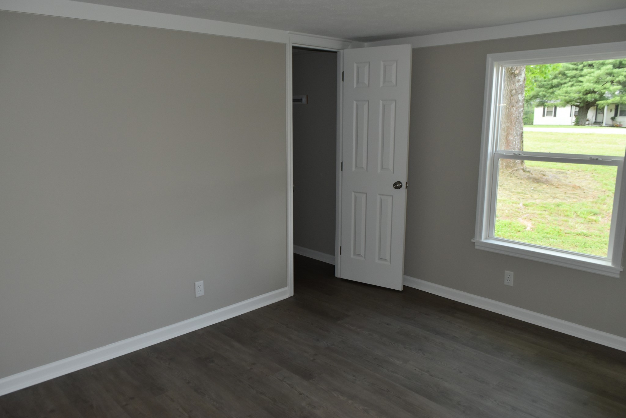 149 Harbin Road Fayetteville, TN 37334 - Photo 9 of 12 an empty room with wooden floor and windows